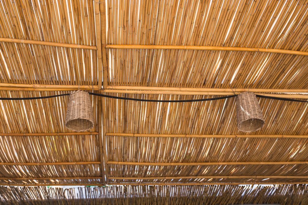 Lighting and illumination concept - Lamps ceiling lights are hanging from bamboo roof